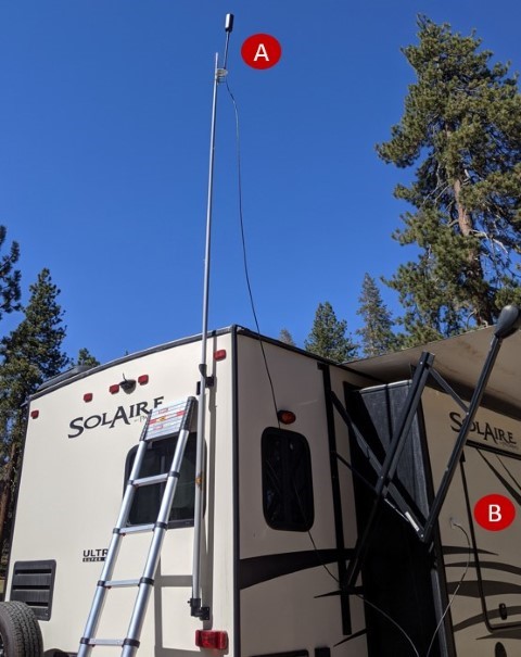 WeBoost signal booster on a flag pole attached to the RV